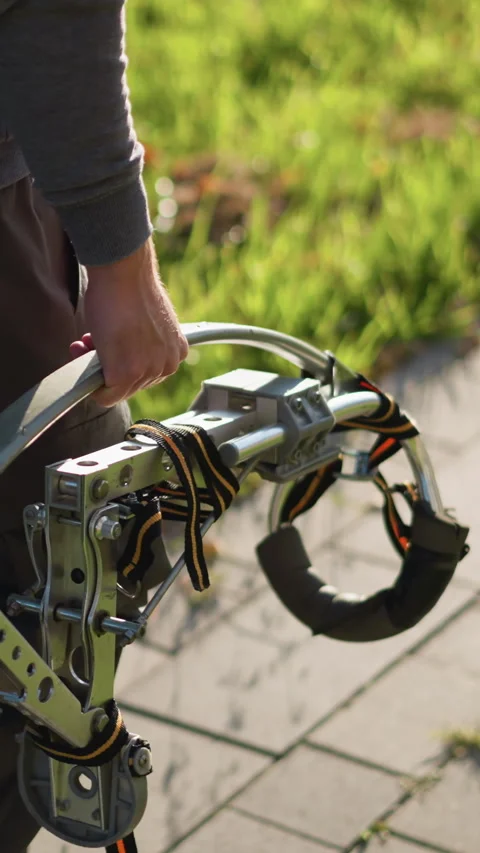Guy Holding Spring-Loaded Metal Stilts w... | Stock Video | Pond5