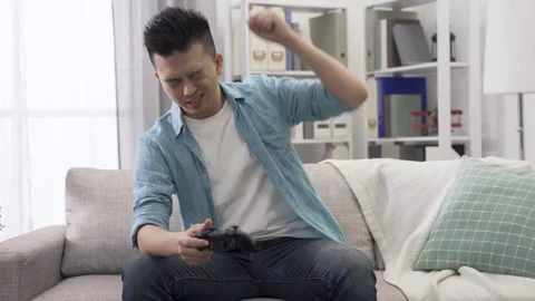 Guy holding wireless controller auto racing Video stock 140149580