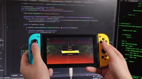 A guy holds a Nintendo switch Stock Footage 219565163