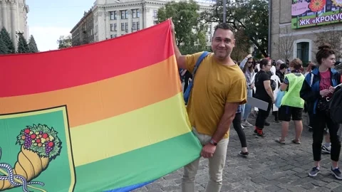 The guy holds a rainbow flag in his hands during the pride Stock Footage 172441762