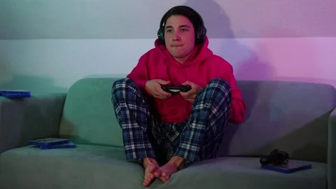 Guy in home clothes on sofa and plays video games.very difficult computer game Stock-Footage 253825693