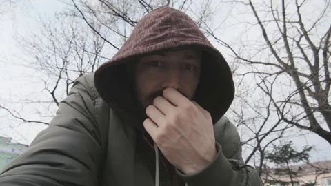 The guy in the hood says turning to the camera Stockbeeldmateriaal 119672152