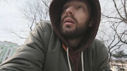 The guy in the hood says turning to the camera Stock Footage 119673638