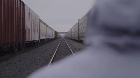 Guy In Hoodie Looks Down Train Tracks Video stock 270325280