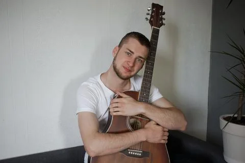 A guy hugs a guitar Stock Photos