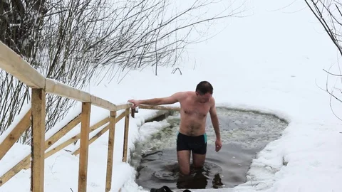 The guy is immersed in the icy water Stock Footage 85643441