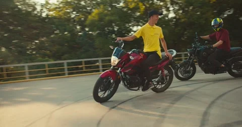 Guy instructor in a yellow T-shirt trains his student to ride a motorcycle Stock Footage 249435420