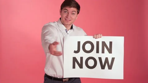 Guy Invites Camera With "Join Now" Sign, Studio Shoot Stock Footage 140531683