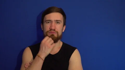 The guy irritated and he is scratching his beard Stock Footage 124304924