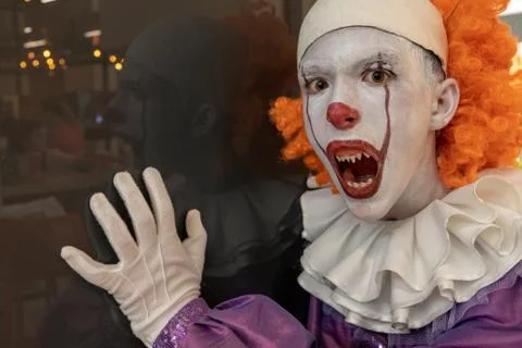 The guy in the IT suit opened his mouth. The face is a very scary clown with  Stock Photos