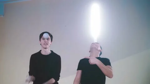 The guy juggles while the other holds the light on his nose Stock Footage 169713017