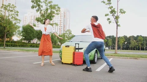 A guy in a jump slaps his girlfriend's palms with joy against the background of Stock Footage 220662072