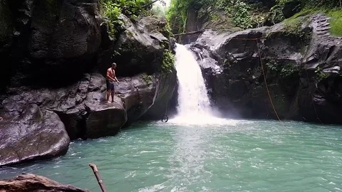 Guy jumped into a waterfall Video stock 122965728