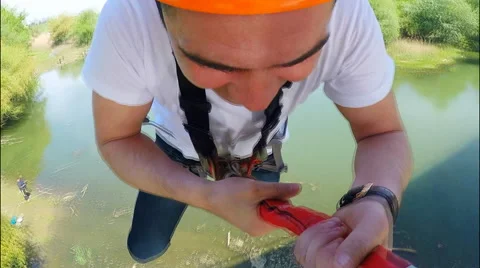Guy jumping from the bridge facing forward arms outstretched Stock Footage 49913010