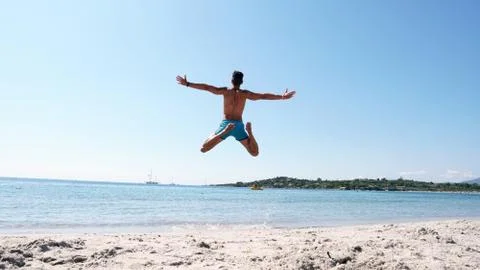 A guy jumping into the sea Stock Photos