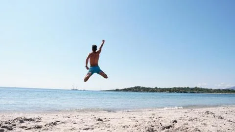 A guy jumping into the sea Stock Photos