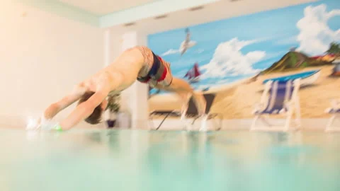 Guy jumping into a swimmingpool underwater Stock Footage 153516267