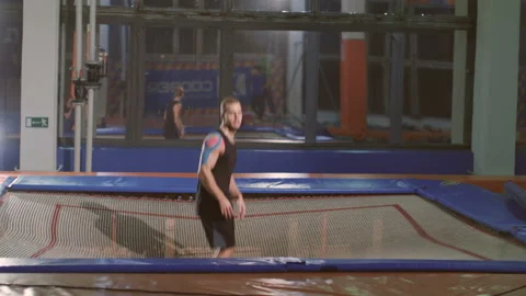 A guy jumping on the tramboline. Stock Footage 96637835