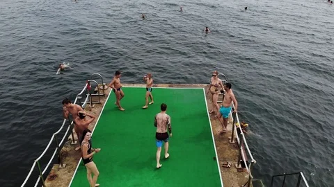 Guy jumping in water from the pierce Stock Footage 106472736