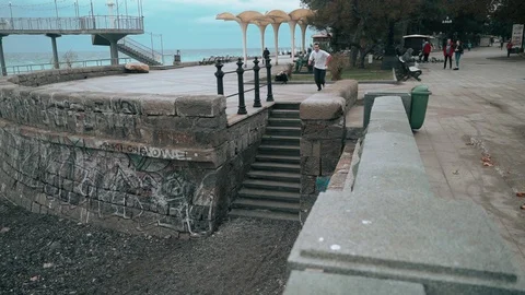 The guy jumps all the steps in the city near the sea. The guy is training Stock Footage 120423606