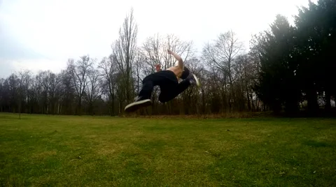 Guy jumps backflip in the park, slowmotion Stock Footage 48422632