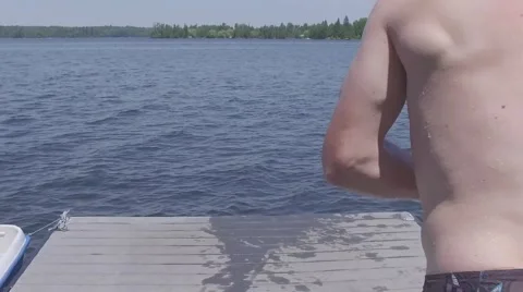 Guy jumps off dock cannonball super slow motion 120fps Stock Footage 65050825