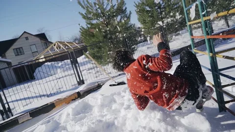 The guy jumps off with a flip in the snow standing on a horizontal bar Stock Footage 235876552