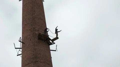 A guy jumps from a high abandoned pipe with insurance, a man falls from a height Stock Footage 181935491