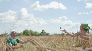 The guy Jumps out of the Grass and Tries to Catch Apples. Summer Stock Footage 85486988