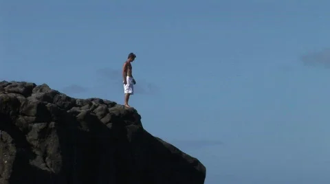 Guy jumps off rocks  Stock Footage 313893