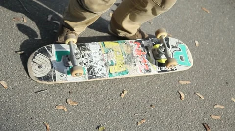 The guy jumps on a skateboard, starts moving, close-up Stock Footage 63210110