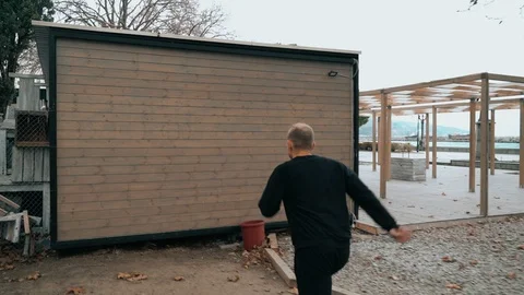 The guy jumps on the structure of the house. The guy is training parkour. Jumps Stock Footage 120423513