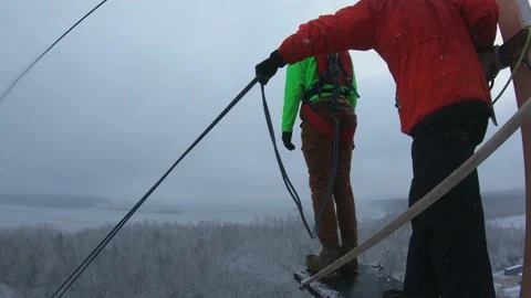 A guy jumps from a tower, a man falls from a height, a jump with a rope Stock Footage 172230153