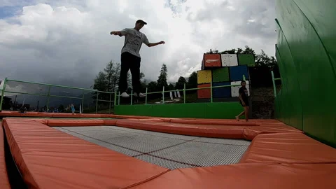 Guy jumps on a trampoline and falls 스톡 동영상 102323071