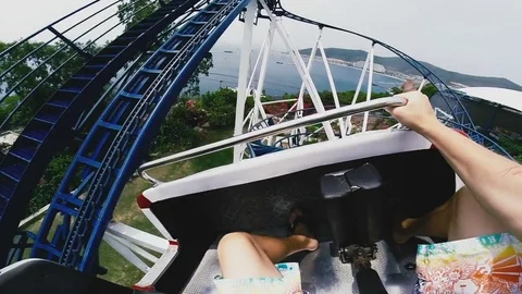 Guy keeps his hands on the handrail on the attraction Stock Footage 80535682