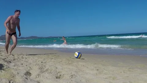 Guy kicking ball at beach in slow motion 動画素材 88601323