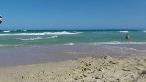 Guy kicking ball at beach in slow motion Stock Footage 88601352
