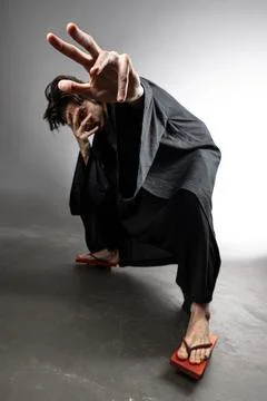 A guy in a kimono and geta in the image of a charismatic villain, Stock Photos