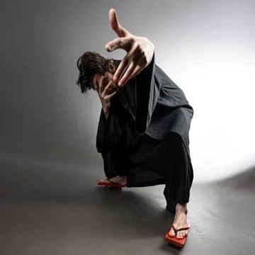 A guy in a kimono and geta in the image of a charismatic villain, Stock Photos