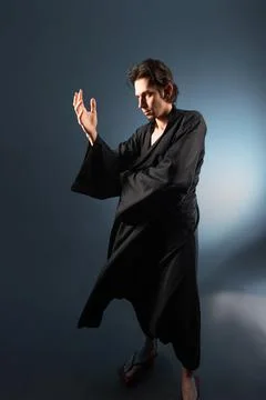 A guy in a kimono and geta in the image of a charismatic villain, Stock Photos