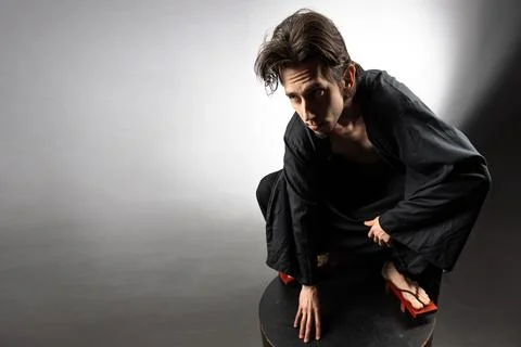 A guy in a kimono and geta in the image of a charismatic villain, Stock Photos