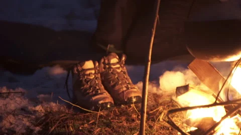 The guy kindled a fire and is going to spend the night in a snowy forest. Stock Footage 220738800