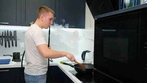 Guy in Kitchen Making Dinner. Relaxes After Hard Day. Smokes Hookah. Smoke Stock Footage 147345897
