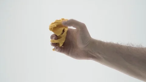 The guy kneads in hand modeling clay. white background 動画素材 105861227