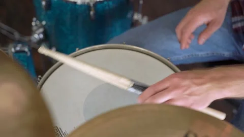 The guy knocks on the drums and then puts the sticks on the drum Stock Footage 155554520