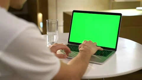 Guy with a laptop with a green screen Stock Footage 131511486