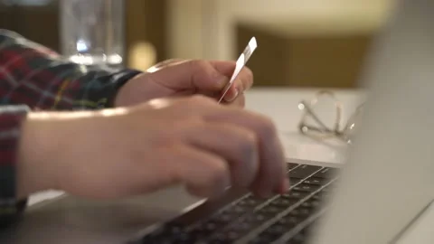 A guy with a laptop makes a card purchase Stock Footage 131511522