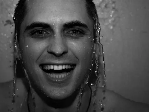 The guy is laughing in the shower Stock Photos