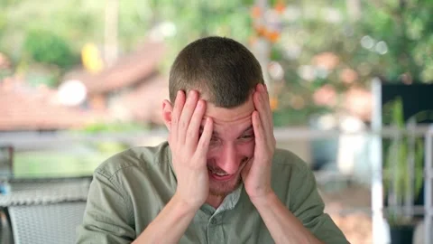 The guy laughs nervously on the verge of a nervous breakdown. Video stock 231336351