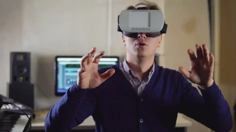 The guy laughs via virtual reality glasses in a recording Studio Stock Footage 72445818